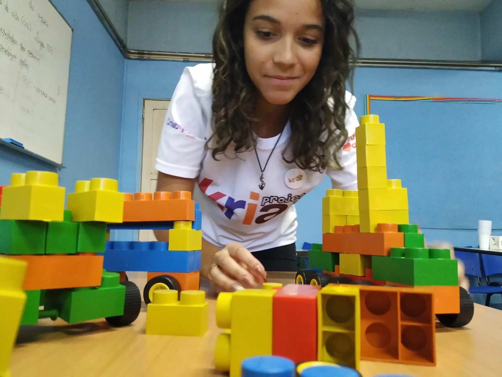 Estudante cria uma estrutura colorida com blocos em atividade maker